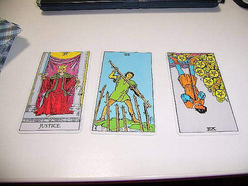 A three-card tarot spread depicting Rider-Waite-Smith imagery